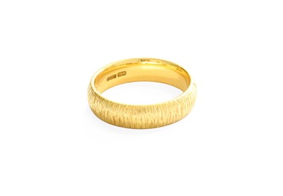 Lot 18 - An 18 Carat Gold Textured Band Ring, finger...
