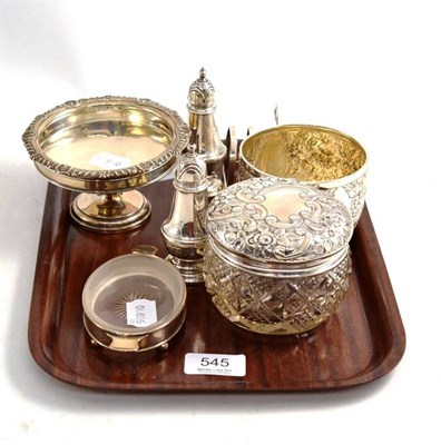 Lot 545 - A tray of silver items comprising a Victorian foliate embossed sugar bowl, a cut glass dressing...