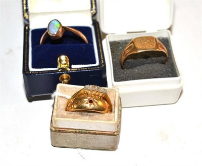 Lot 550 - An opal ring, a signet ring, a diamond two stone ring af and another