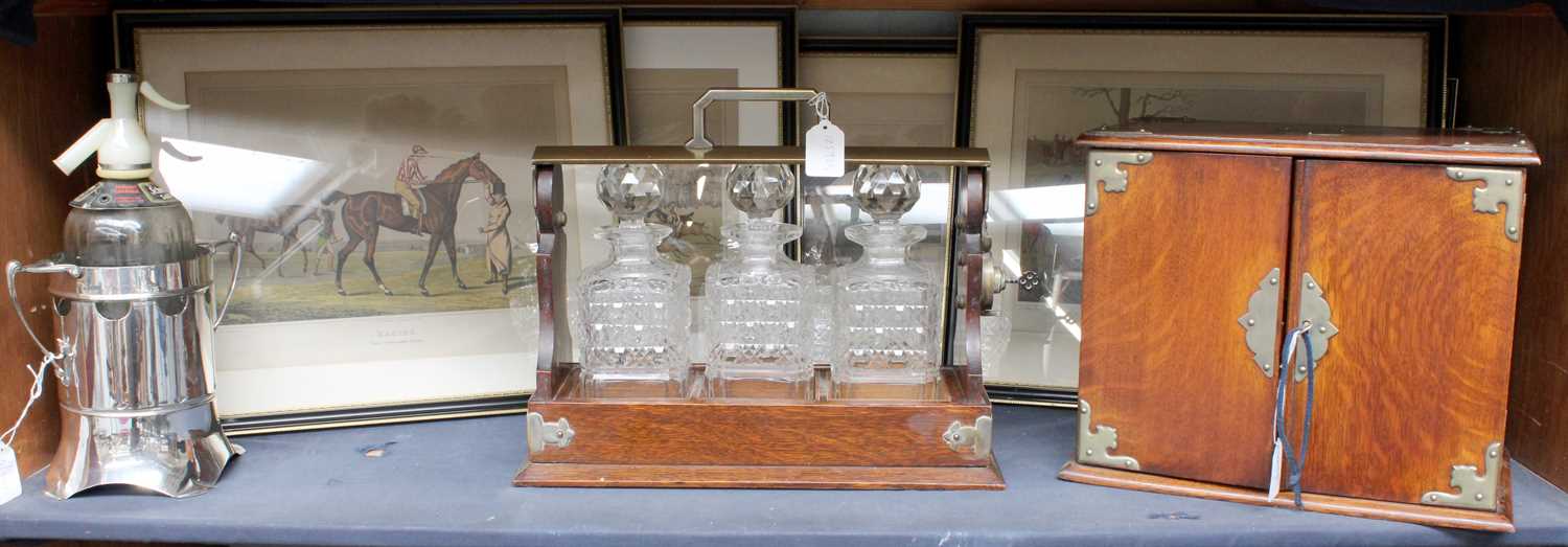 Lot 79 - A 1920s Oak Three Bottle Tantalas, oak smokers...
