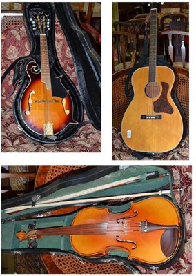 Lot 559 - Three stringed instruments comprising a Chinese viola with two bows in a hard case; a...