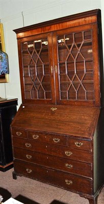 Lot 636 - A George III oak bureau bookcase