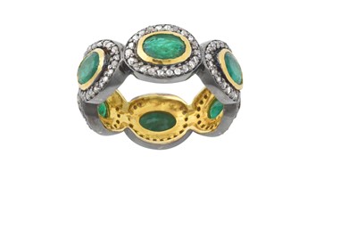 Lot 2130 - An Emerald and Diamond Eternity Ring six oval...