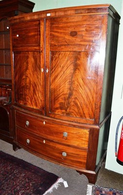 Lot 644 - A Regency mahogany bow fronted linen press with hanging space