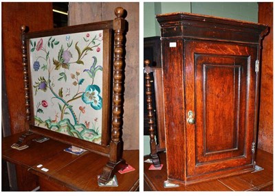 Lot 653 - A George III oak straight fronted corner cupboard, a warming pan and a firescreen