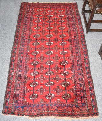 Lot 1011 - Baluch Rug, the crimson field with columns of...