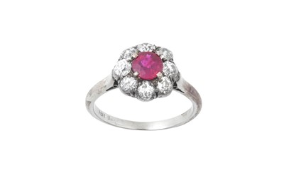 Lot 2171 - A Ruby and Diamond Cluster Ring the round cut...