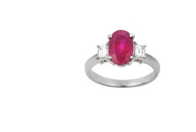 Lot 2186 - A Ruby and Diamond Three Stone Ring the oval...