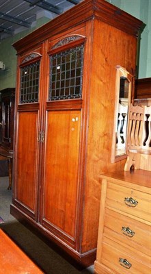 Lot 662 - A late Victorian mahogany cloak room cupboard with stained glass panels