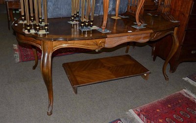 Lot 675 - A French style dining table with two extra leaves, quartered tops and cabriole legs