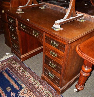 Lot 680 - A Victorian walnut knee hole desk with brass handles