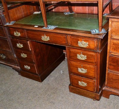 Lot 688 - Oak pedestal desk with green leather top on castors