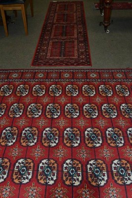 Lot 695 - Machine made carpet of Turkman design, Europe, the rust field with five columns of guls enclosed by