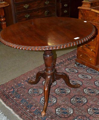 Lot 696 - A mahogany tilt top table