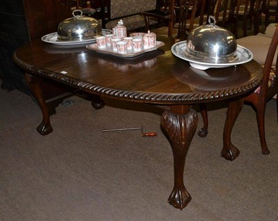 Lot 701 - A mahogany wind out table with claw and ball feet