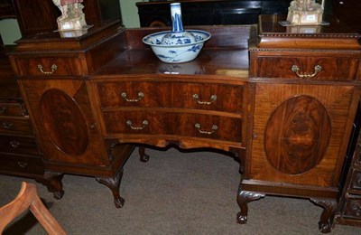 Lot 703 - A mahogany pedestal sideboard with brass handles and carved moulding