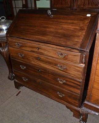 Lot 704 - A 19th century mahogany slope front bureau, with fitted interior above four graduated long...