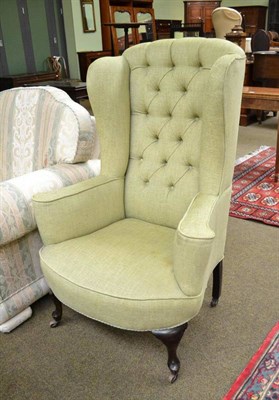 Lot 730 - A green upholstered wing back chair