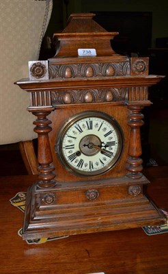 Lot 738 - A striking mantel clock in an oak case