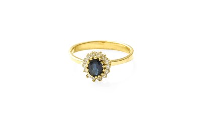 Lot 362 - A Sapphire and Diamond Cluster Ring, the oval...