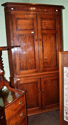 Lot 771 - A Georgian cross banded oak floor standing corner cupboard