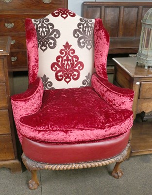 Lot 1328 - A Georgian Style Wingback Armchair, red...