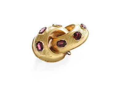 Lot 557 - A Garnet Brooch, the scroll motif decorated...