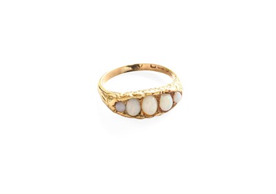 Lot 556 - An 18 Carat Gold Opal Ring, three graduated...