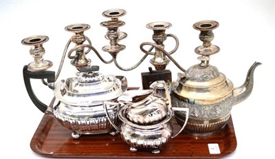 Lot 4 - An Indian silvered metal teapot, a three piece plated tea service and a pair of candlesticks