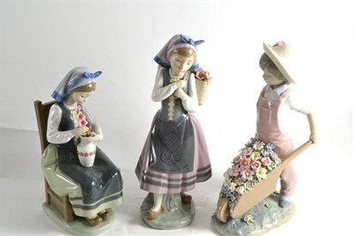 Lot 33 - Three Lladro figures 'Flower Harmony' 01418, 'Wheelbarrow with Flowers' 01283 and 'Nature's Bounty'