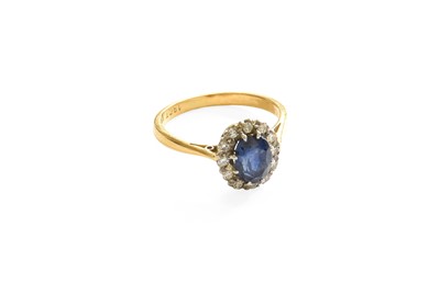 Lot 501 - A Sapphire and Diamond Cluster Ring, the oval...