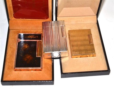 Lot 58 - Two gold plated Dupont lighters and a silver coloured Dupont lighter