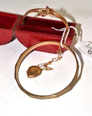 Lot 59 - One 9ct gold hinged bangle in fitted case, a 9ct gold bangle and a heart shaped locket