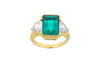 Lot 2312 - An Emerald and Diamond Three Stone Ring the...