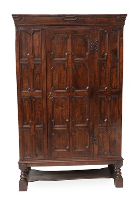 Lot 631 - A 17th Century Style Oak Press Cupboard, the...