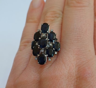 Lot 2109 - A Sapphire and Diamond Ring nine oval cut...