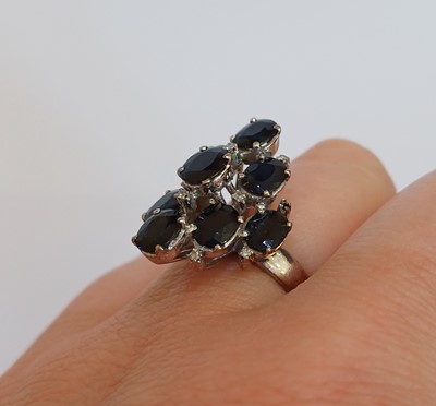Lot 2109 - A Sapphire and Diamond Ring nine oval cut...
