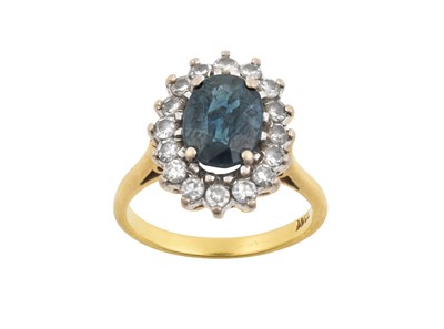 Lot 2191 - A Sapphire and Diamond Cluster Ring the oval...