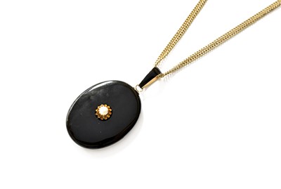 Lot 338 - An Onyx, Enamel and Pearl Locket, the oval...