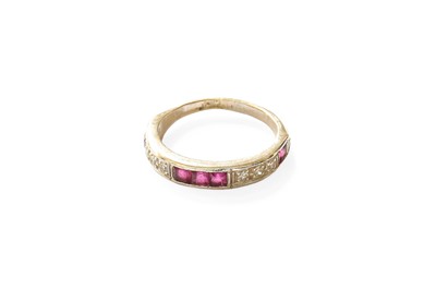 Lot 399 - A Ruby and Diamond Half Hoop Ring, calibré cut...