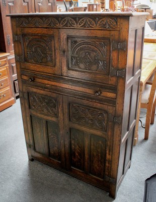 Lot 1301 - A 20th Century Carved Oak Four Door Cupboard,...