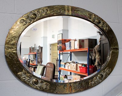 Lot 1274 - An Arts & Crafts Brass Oval Mirror, with...