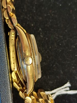 Lot 2138 - Rolex: A Rare 18 Carat Gold Automatic Day/Date...