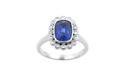 Lot 2241 - A Platinum Sapphire and Diamond Cluster Ring...