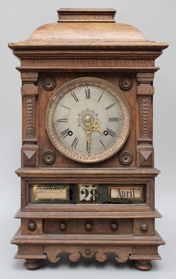 Lot 1474 - A German Oak Cased Striking Mantel Clock, with...