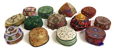 Lot 2122 - Thirteen Afghan and Eastern Hats woven in...