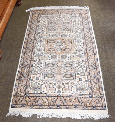 Lot 1286 - Indian Rug, the ivory field with three panels...