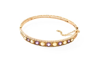 Lot 402 - A 9 Carat Gold Amethyst and Split Pearl Bangle,...