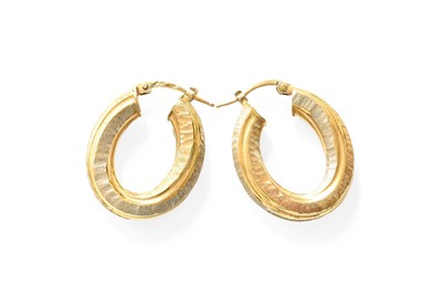 Lot 434 - A Pair of Bi-Colour Textured Hoop Earrings,...