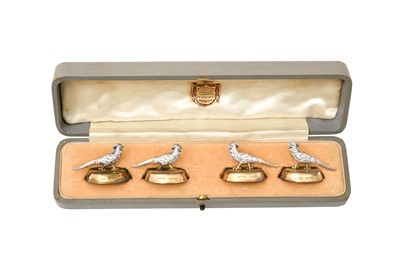 Lot 2345 - A Cased Set of Four George V Parcel-Gilt Silver Place-Card Holders